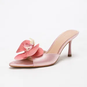 Elegant pink satin high heel mules with oversized orchid flower and pointed toe