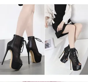Detailed view of black mesh peep-toe lace-up high-heel platform sandals on a model.