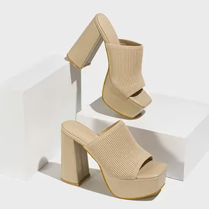 Close-up detail of beige knitted platform sandals with square toe and chunky block heels