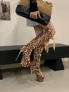 Close-up view of leopard print lace-up high heel boots featuring a sexy hollow out design.