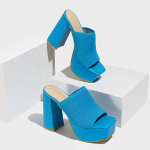 Detail of blue knitted platform mules featuring a chunky high heel and square toe