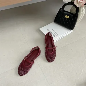 Detailed view of red mesh flat shoes with elegant silver embroidery and buckle strap.