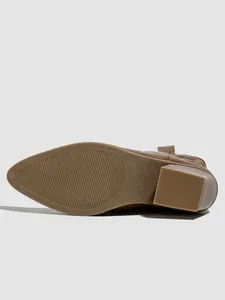 Close-up of the anti-slip textured sole with size 36 mark on brown pointed-toe boots