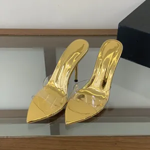Close-up of elegant gold pointed-toe high heel mules featuring a transparent front strap