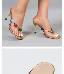 Golden bohemian thong sandals featuring vibrant colorful stones and elegant slim high heels