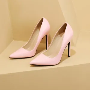 Close-up of elegant pink patent leather pointed-toe pumps with slim stiletto heels.