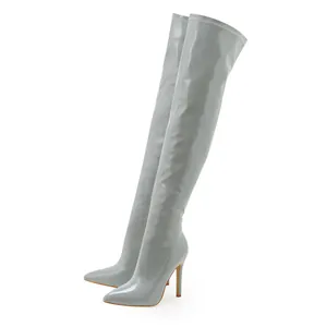 Detailed view of stylish grey patent leather over-the-knee boots with pointed toes