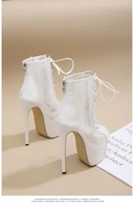 Detailed side view of white lace-up mesh high-heeled boots with platform and stiletto heel.