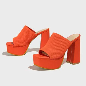 Vibrant orange knitted platform sandals featuring chunky high heels and square peep toes.