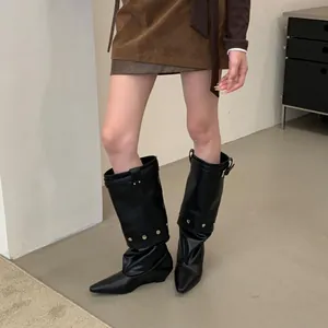 Chic black pointed-toe leather pants boots with stylish silver rivets and wedge heel.