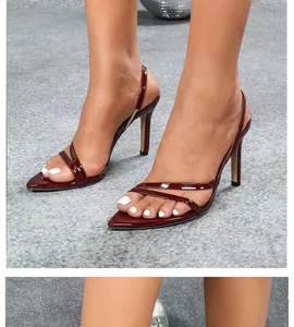 Close-up view of elegant red patent leather high-heeled slingback sandals with thin straps