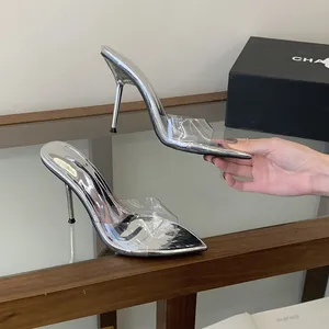 Detail of silver pointed toe high heel sandals featuring a clear transparent PVC strap