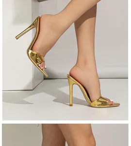 Detailed view of gold metallic stiletto mules with pointed toe and single strap design