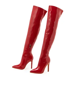 Full view of red patent leather over-the-knee boots with stiletto heels and pointed toes