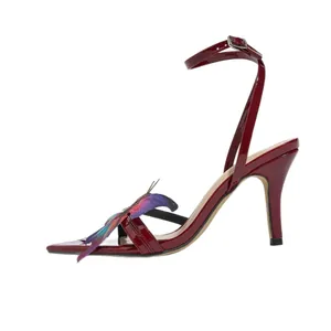 Elegant burgundy high heel sandals with butterfly decoration and square toe design.