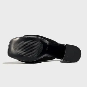 Detailed sole view of a black knitted square-toe platform mule showing the chunky heel