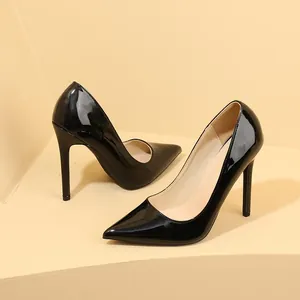Close-up of elegant black patent leather stiletto heels with a sharp pointed toe.