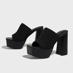 Detailed view of women's black knit platform mules with a chunky high heel and square toe