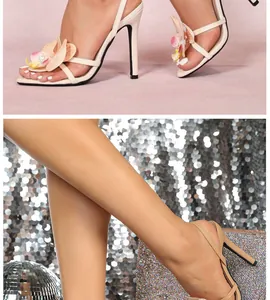 Detail of elegant stiletto sandals with 3D orchid flower decor and ankle strap