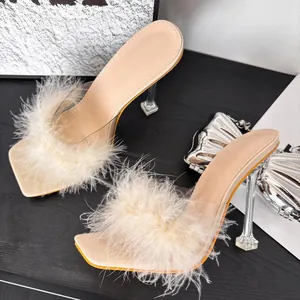 Elegant beige high-heeled mules with fluffy fur trim and transparent square heels