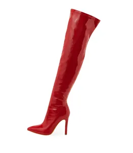 Side view of elegant red patent leather thigh-high boots with pointed toe and stiletto heel