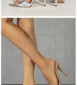 Close-up view of elegant silver and nude stiletto high-heel sandals for party wear