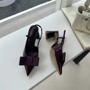 Elegant burgundy pointed-toe slingback pumps with large bow detail and sturdy block heel