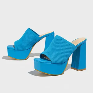 Detailed view of women's bright blue knitted platform mules with chunky high heels