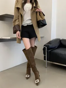Brown suede over-the-knee boots featuring a crystal buckle and sleek stiletto heels.