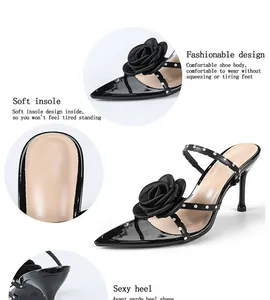 Detail view of black pointed toe sandals with 3D rose and polka dot straps