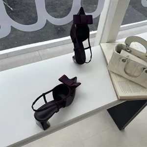 Elegant maroon pointed-toe slingback high heels with a stylish bow detail and chunky heel
