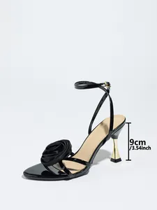 Close-up of black satin high heel sandal with 9cm heel height and rose detail