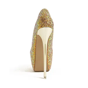 Close-up of sparkling glitter stiletto pump with gold metallic high heel