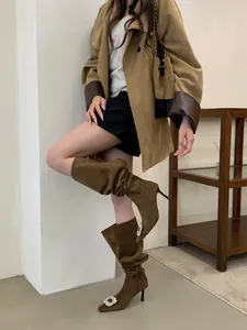 Chic brown suede tall boots featuring a sparkling rhinestone buckle and stiletto heel.