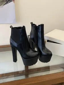 Detailed view of 16cm ultra-high black platform ankle boots with chunky block heels