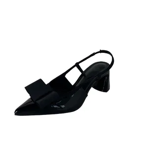 Elegant black patent leather slingback high heels featuring a decorative bow detail.