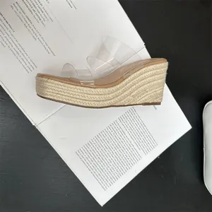 Side profile detail of women's wedge slippers with clear straps and jute-wrapped platform
