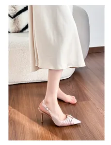 Detailed view of pink pleated satin pointed-toe slingback heels with metal buckle.