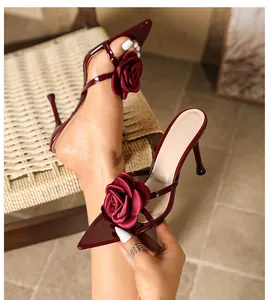 Elegant burgundy pointed-toe stiletto sandals featuring a large decorative silk rose detail