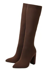 Detailed side view of elegant brown knit stretch knee-high boots with chunky heels