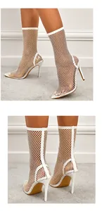 Detail view of white fishnet stiletto boots featuring sparkling rhinestone mesh