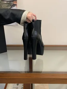 Macro view of black 16cm platform chunky heel Chelsea boots with premium leather finish