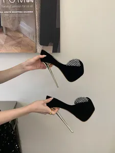 Detailed side view of black platform stiletto pumps with sparkling rhinestone bows