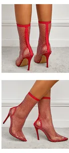Detailed close-up showing red rhinestone fishnet mesh stiletto high heel ankle boots