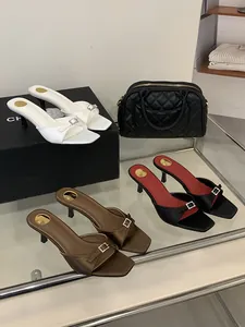 Elegant square toe mule sandals with thin kitten heels and sparkling rhinestone buckle.