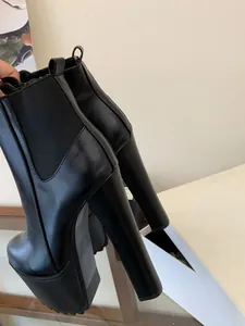 Detailed side view of 16cm ultra high heel black platform Chelsea boots for women