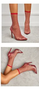 Close-up of red rhinestone mesh ankle boots showing stiletto heels and pointed toe