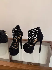 Detailed side view of 16cm black platform stiletto heels with elegant cut-out design