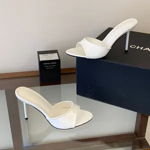 Elegant white patent leather stiletto mules with open-toe design for summer