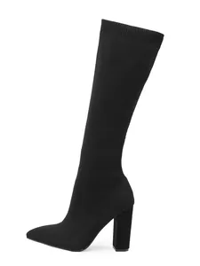 Detailed view of black knit stretch boot featuring pointed toe and block high heel.